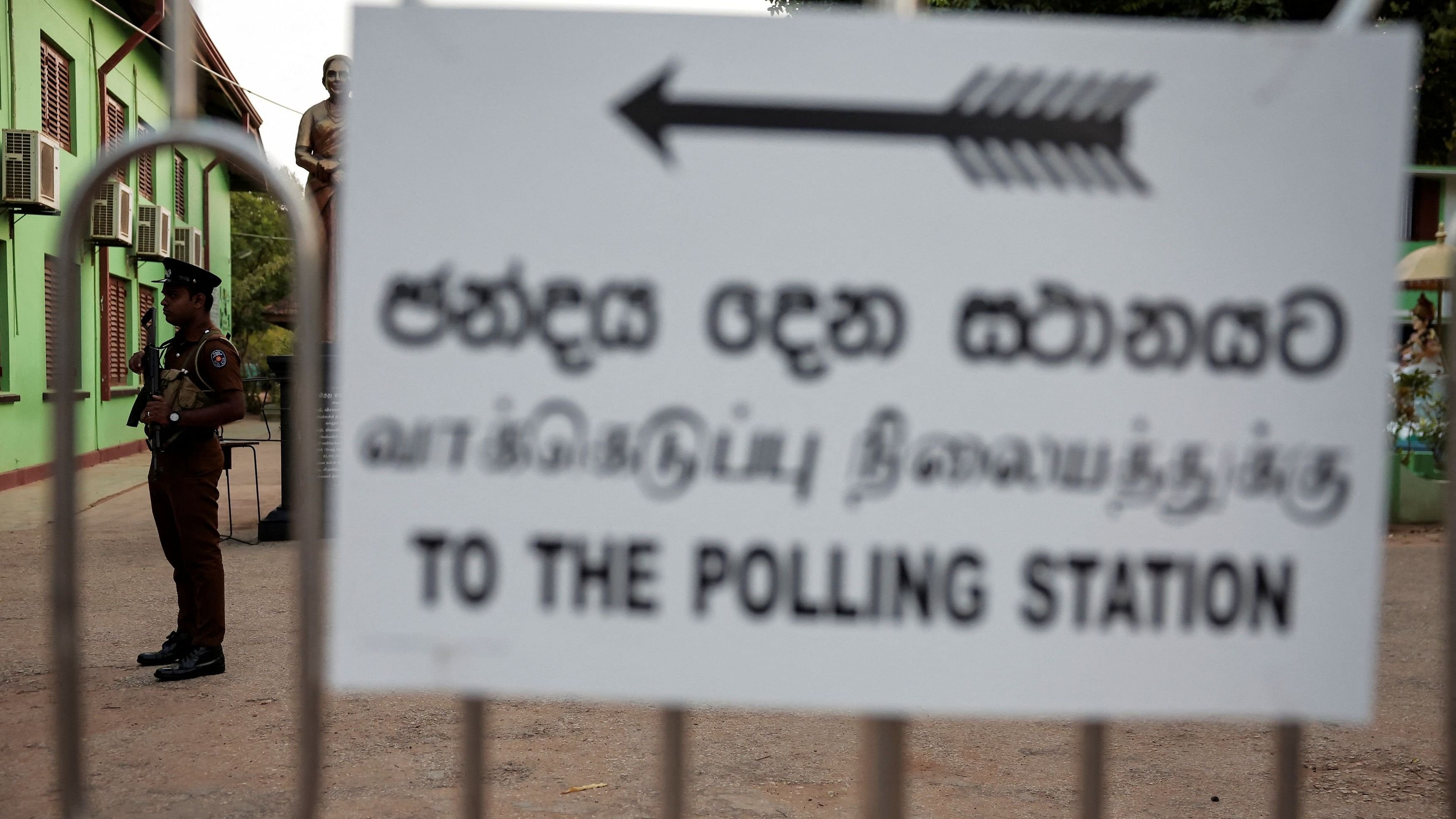 <div class="paragraphs"><p>A police personnel stands guard at a polling station ahead of the start of the voting on the day of the presidential election in Jaffna, Sri Lanka, September 21, 2024. </p></div>