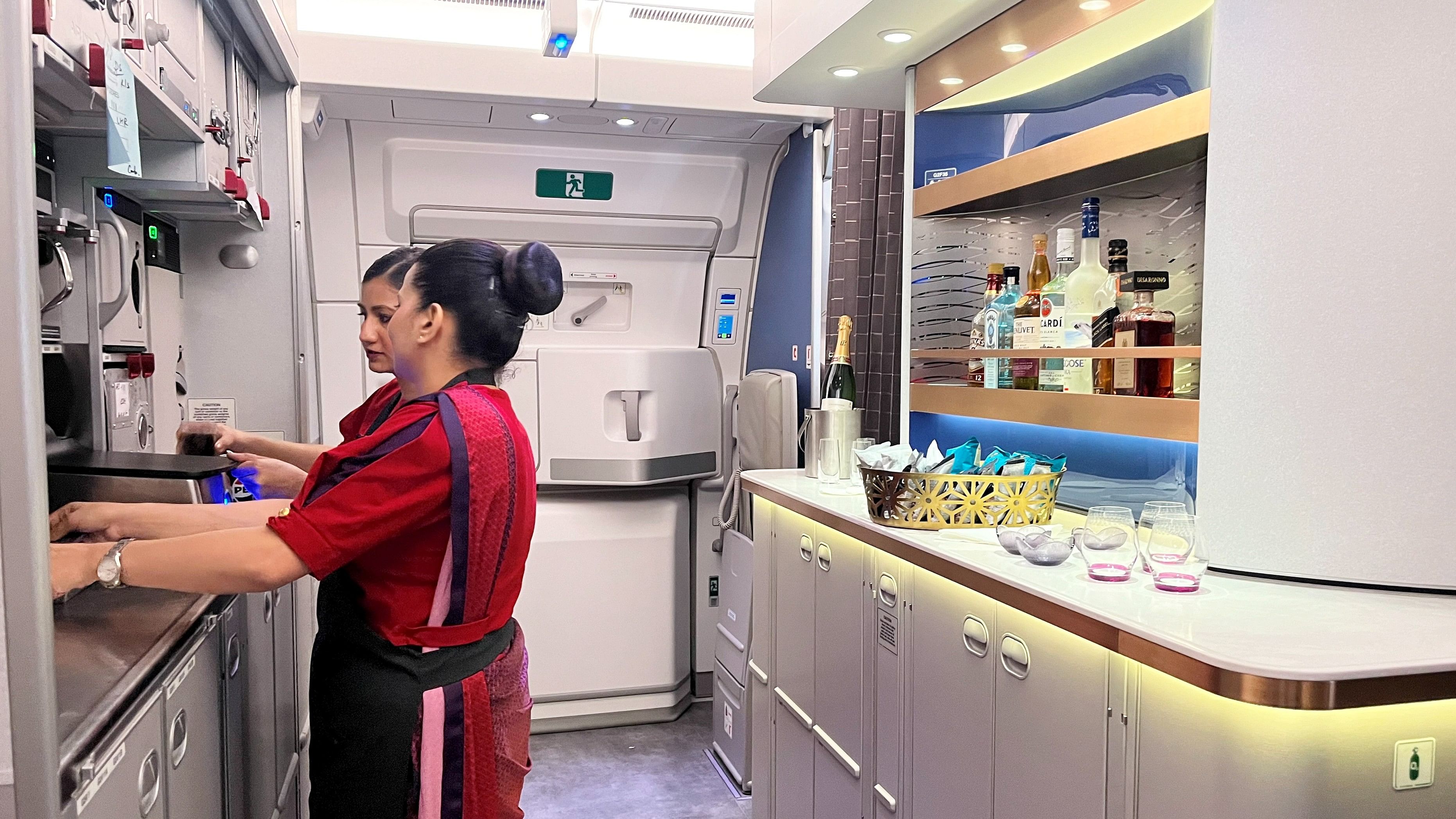 <div class="paragraphs"><p>Staffers work in the kitchen of the Air India A350 aircraft that recently made its international debut.</p></div>