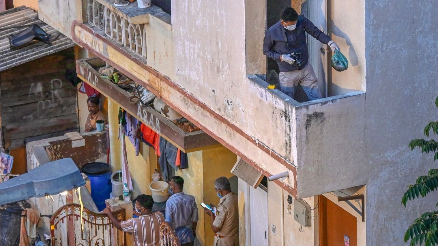 <div class="paragraphs"><p>Police officers and forensic experts examine the Vyalikaval house, where the dismembered body of a 29-year-old woman was discovered on September 21. </p></div>