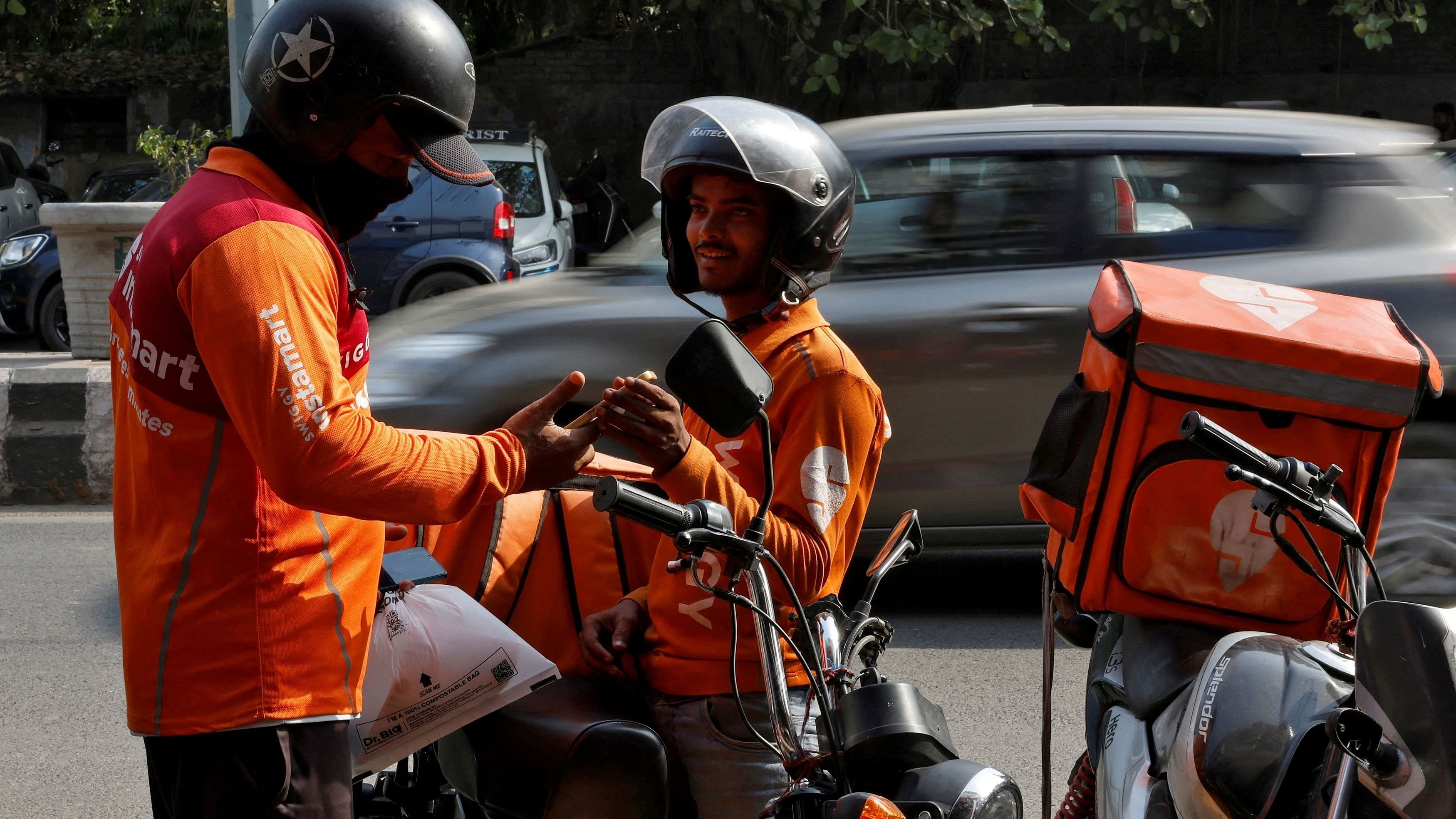 <div class="paragraphs"><p>Gig workers prepare to deliver orders outside Swiggy's grocery warehouse at a market area in New Delhi</p></div>