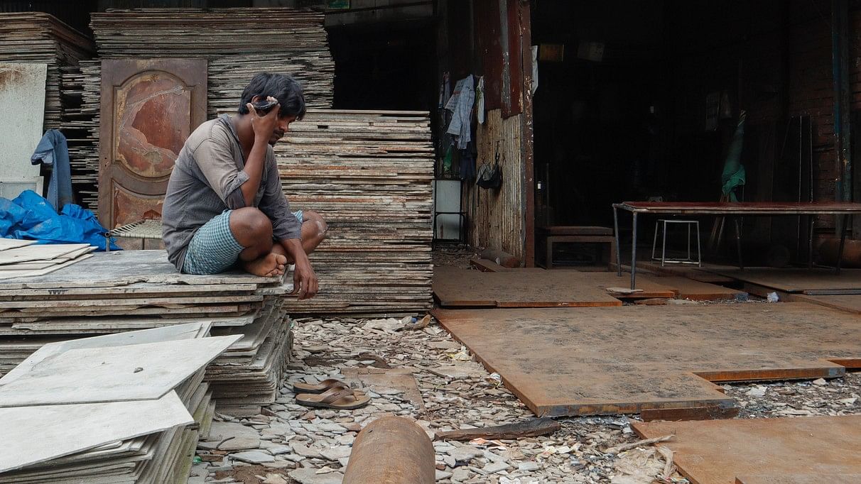 <div class="paragraphs"><p>A labourer sitting out idle outside his asbestos sheet shop in Mumbai. (representative image)</p></div>