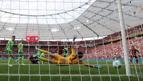 <div class="paragraphs"><p>Bayer Leverkusen's Victor Boniface scores their fourth goal past VfL Wolfsburg's Kamil Grabara.</p></div>