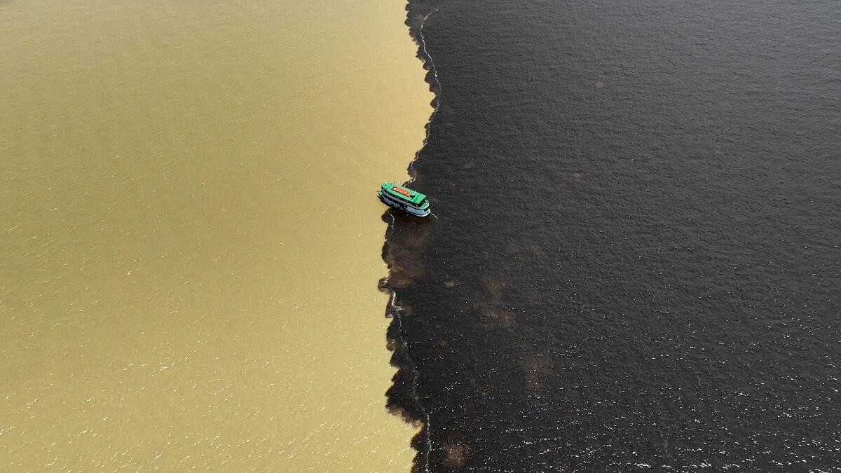 <div class="paragraphs"><p>A drone view shows a boat navigating at the confluence point between the Rio Negro and the Rio Solimoes, to continue into the Amazon river near Manaus, Amazonas state, Brazil September 21, 2024.</p></div>