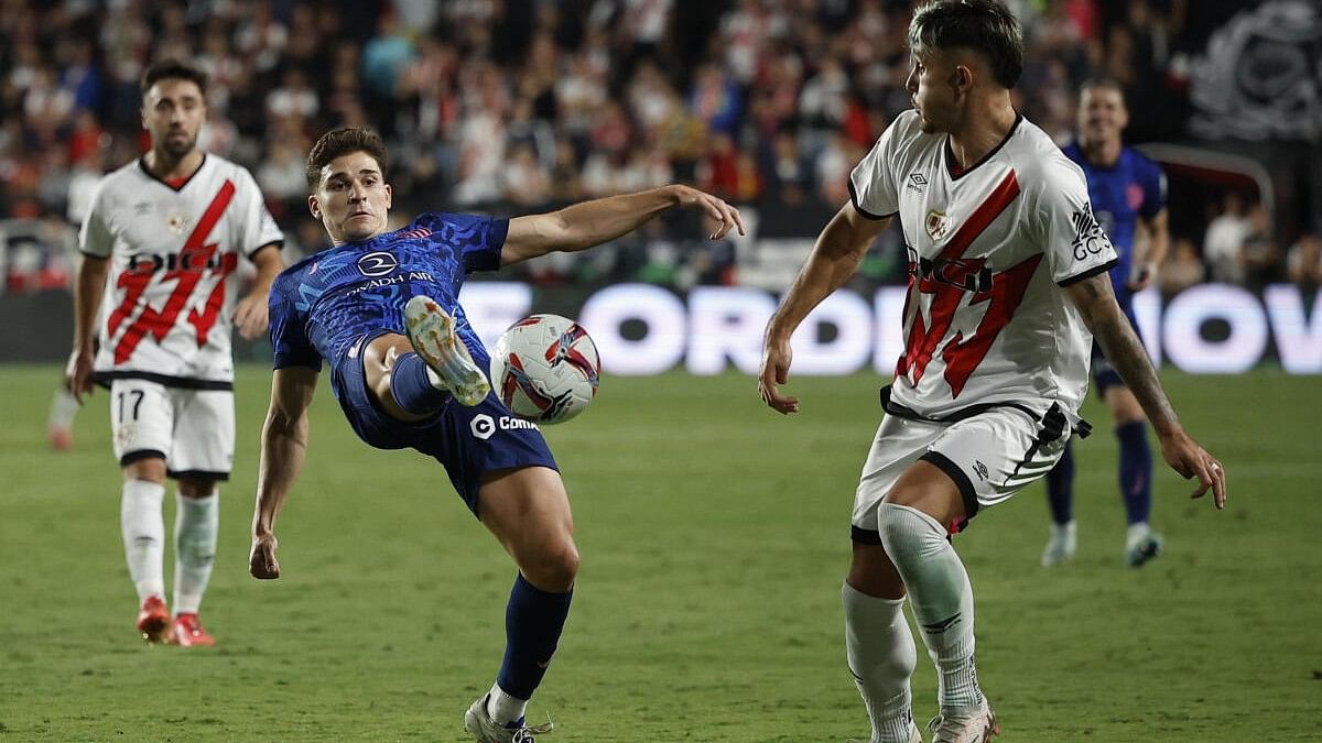 <div class="paragraphs"><p>Atletico Madrid's Julian Alvarez in action with Rayo Vallecano's Andrei Ratiu.</p></div>