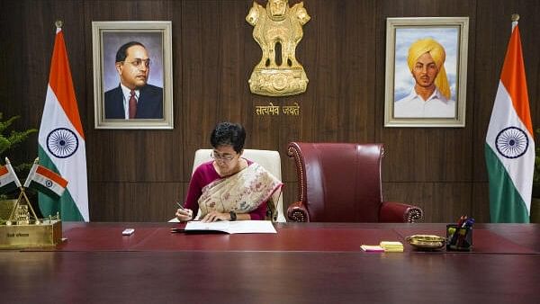 <div class="paragraphs"><p>Newly sworn-in Delhi Chief Minister Atishi takes charge of the office, in New Delhi, Monday, Sept. 23, 2024. Atishi did not sit on the chair used by former CM Arvind Kejriwal and said that his chair would remain unoccupied in the chief minister's office.</p></div>