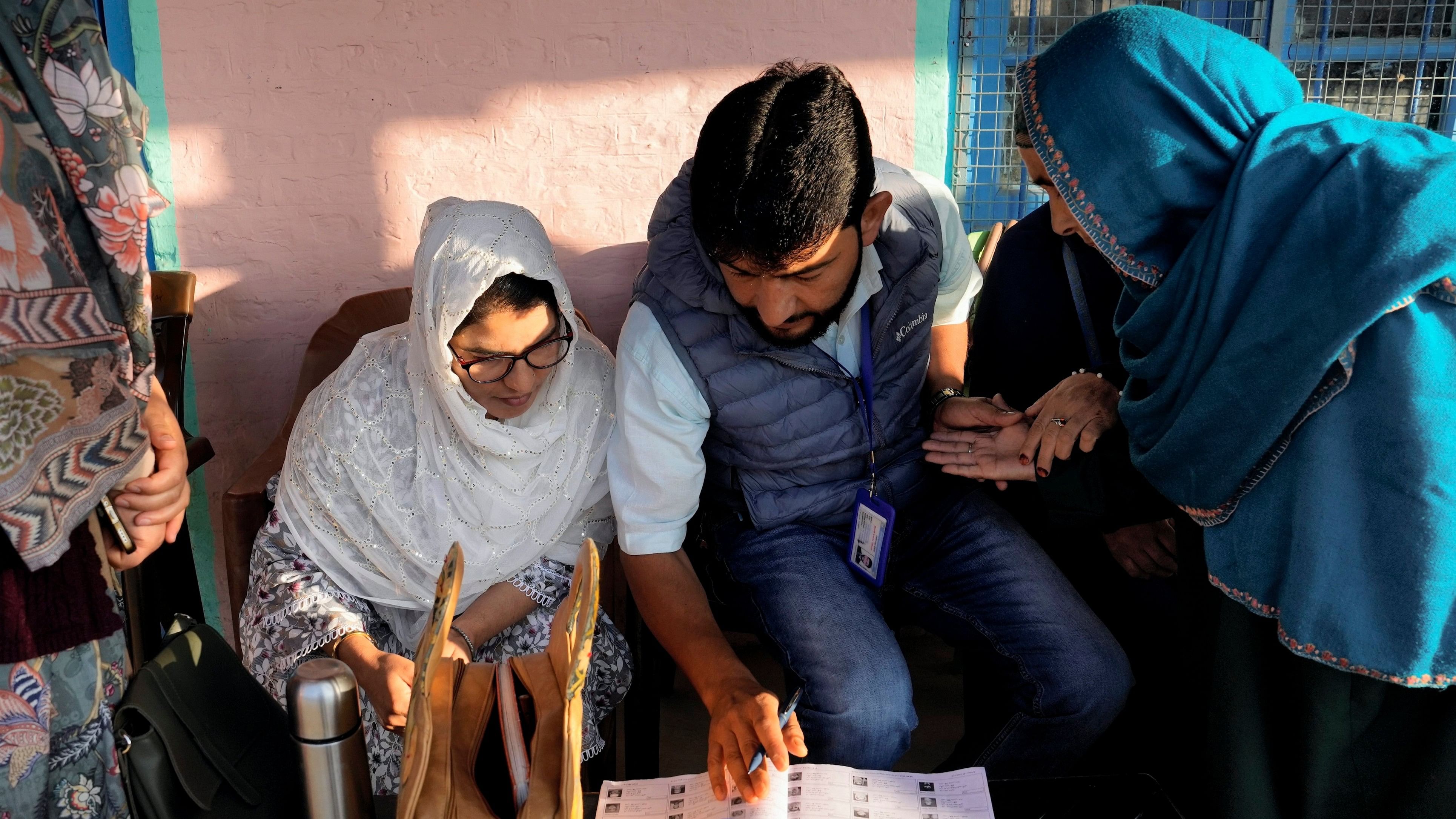 <div class="paragraphs"><p>Pulwama: An elderly voter gets her credentials checked by a Booth Level Officer before casting vote during the first phase of Jammu and Kashmir Assembly elections, in Pulwama district, Wednesday, Sept. 18, 2024. </p></div>