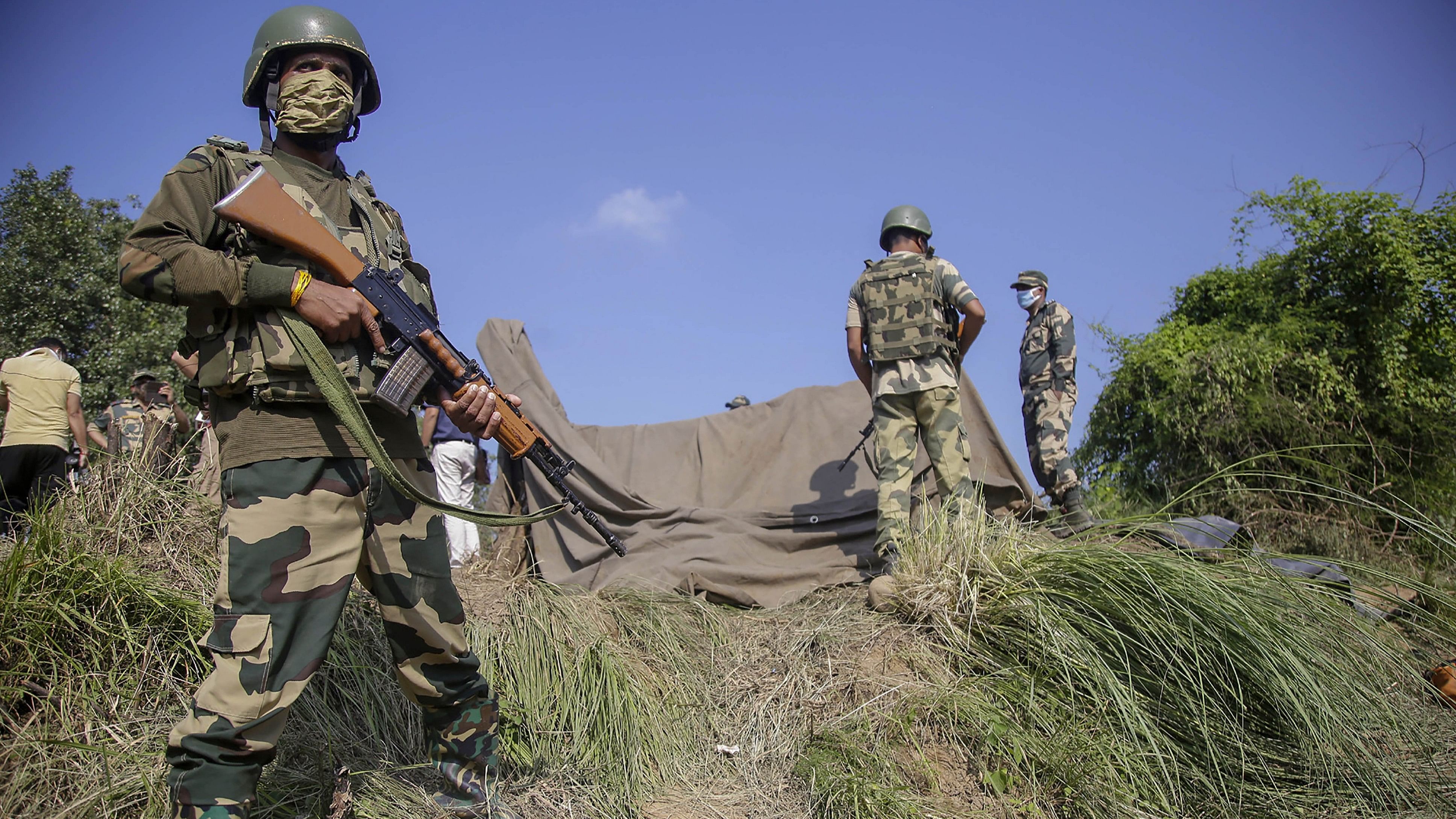 <div class="paragraphs"><p>Border Security Force (BSF) personnel stand near a tunnel, originating from Pakistan, beneath the Indo-Pak international border fence, in J&amp;K's Samba district. </p></div>