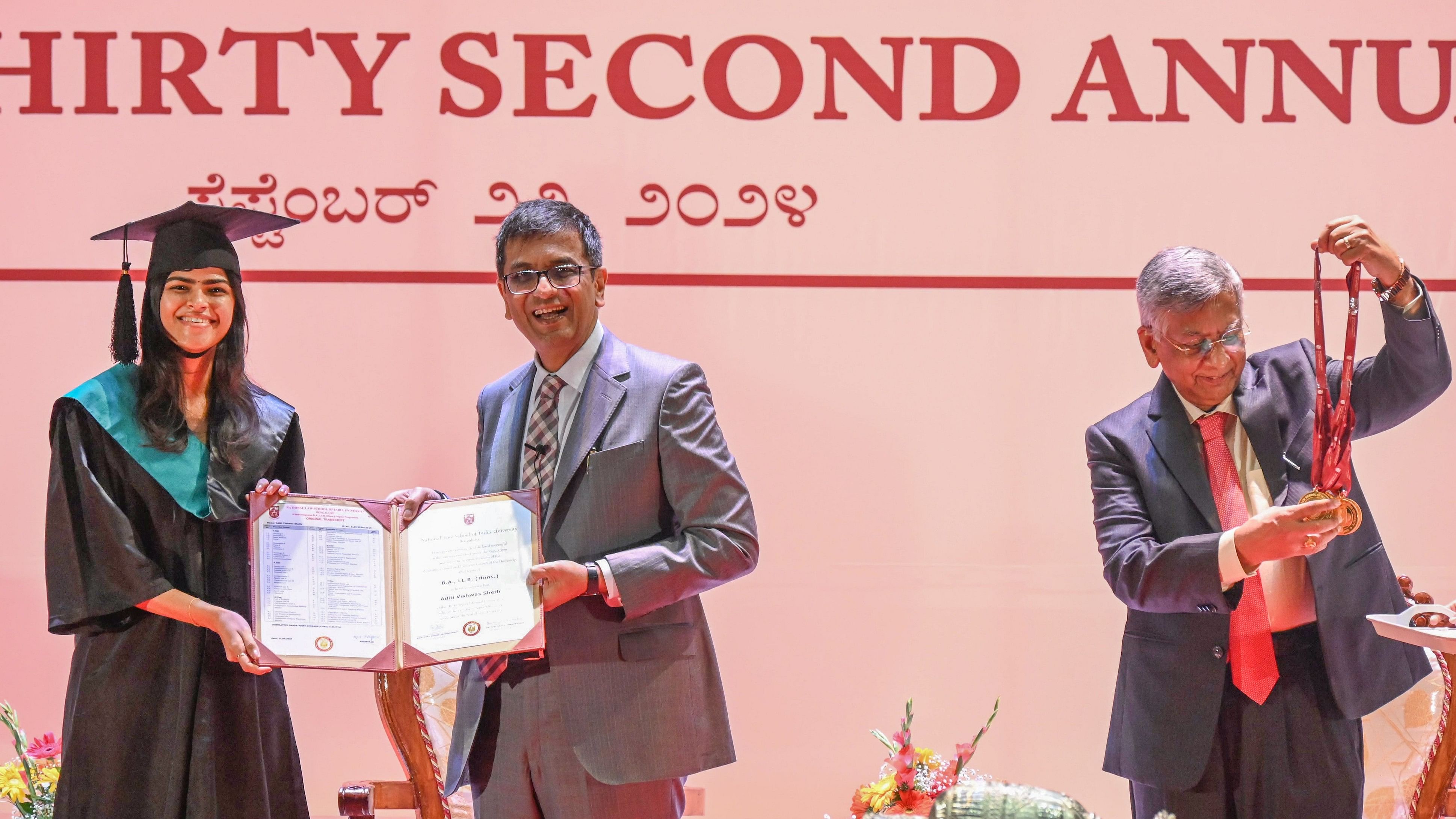 <div class="paragraphs"><p>Chief Justice of India Dhananjaya Y Chandrachud, who is alsoChancellor of National Law School of India, presents the degree certificate to Aditi Viswas Sheth at the 32nd annual convocation of National Law School of India University in Bengaluru on Sunday. Attorney General R Venkataramani is also seen. </p></div>