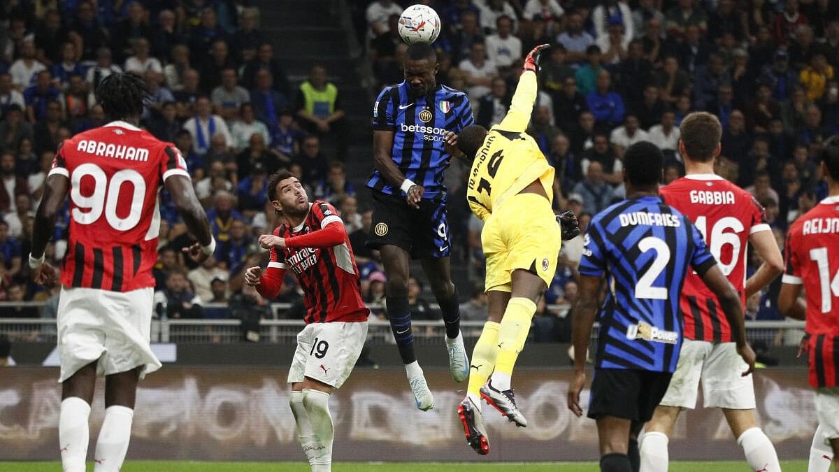 <div class="paragraphs"><p>Inter Milan's Marcus Thuram in action with AC Milan's Mike Maignan.</p></div>