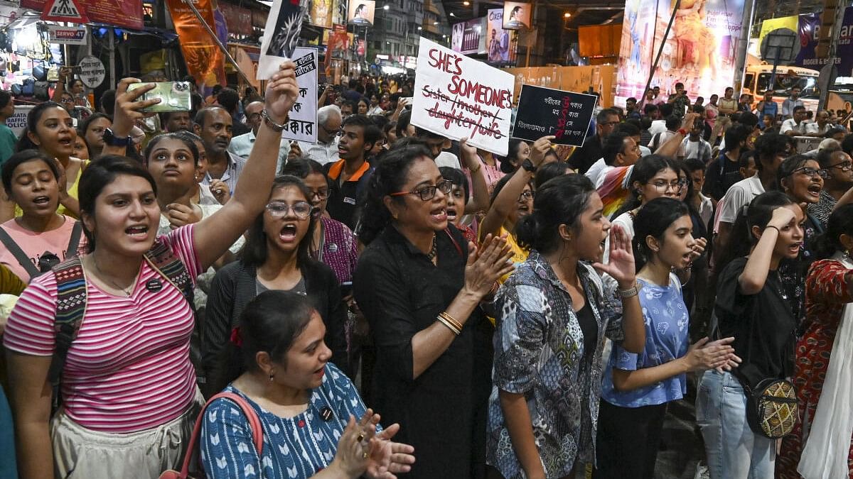 <div class="paragraphs"><p>People take part in a protest march over the alleged sexual assault and murder of a trainee doctor, in Kolkata.</p></div>