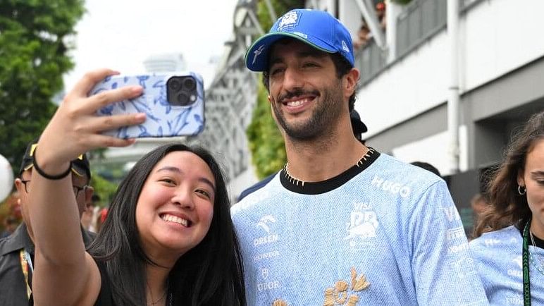 <div class="paragraphs"><p>RB's Daniel Ricciardo posing for a selfie with a fan ahead of practice.</p></div>