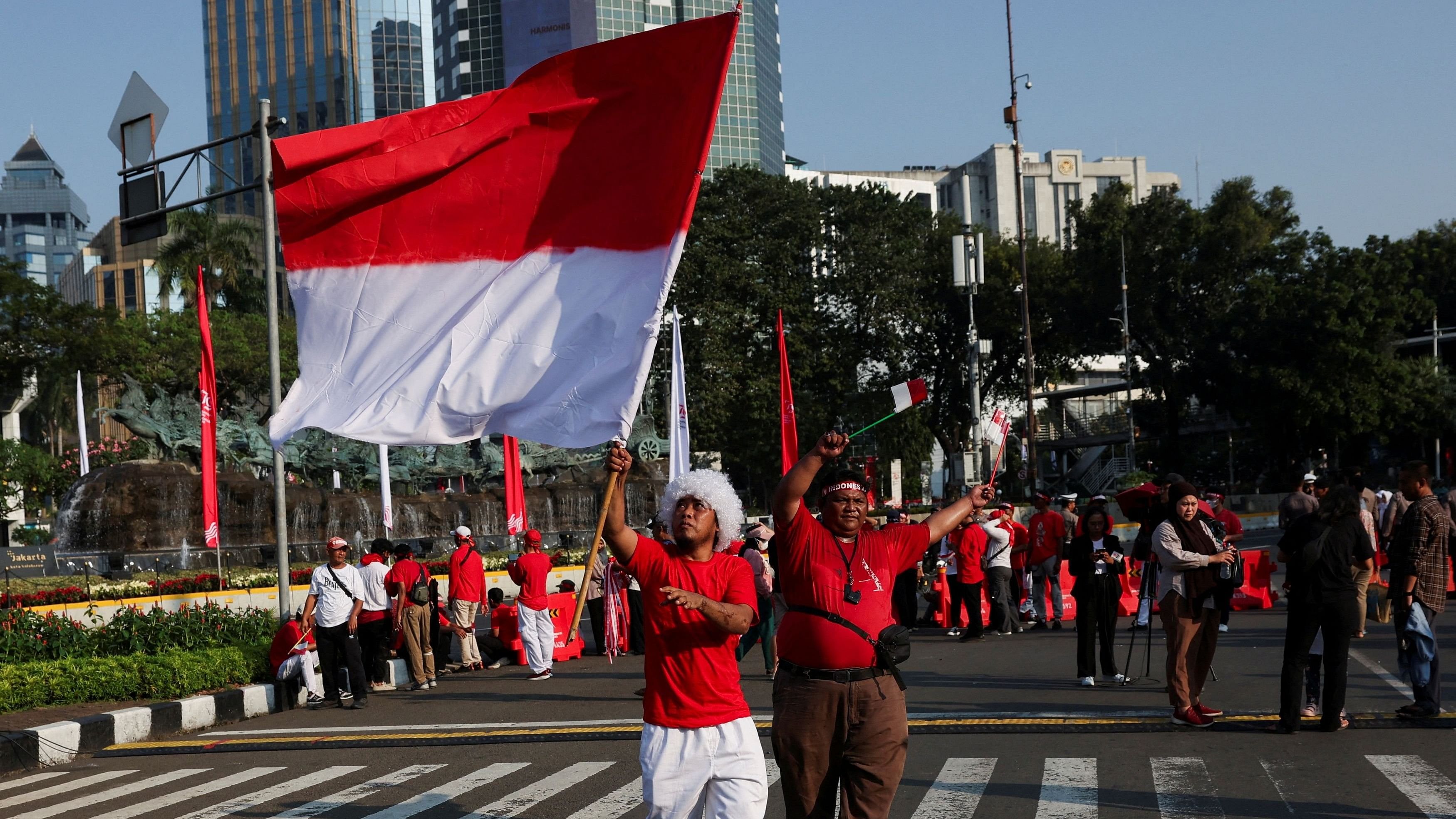 <div class="paragraphs"><p>A man raises Indonesia's flag </p></div>