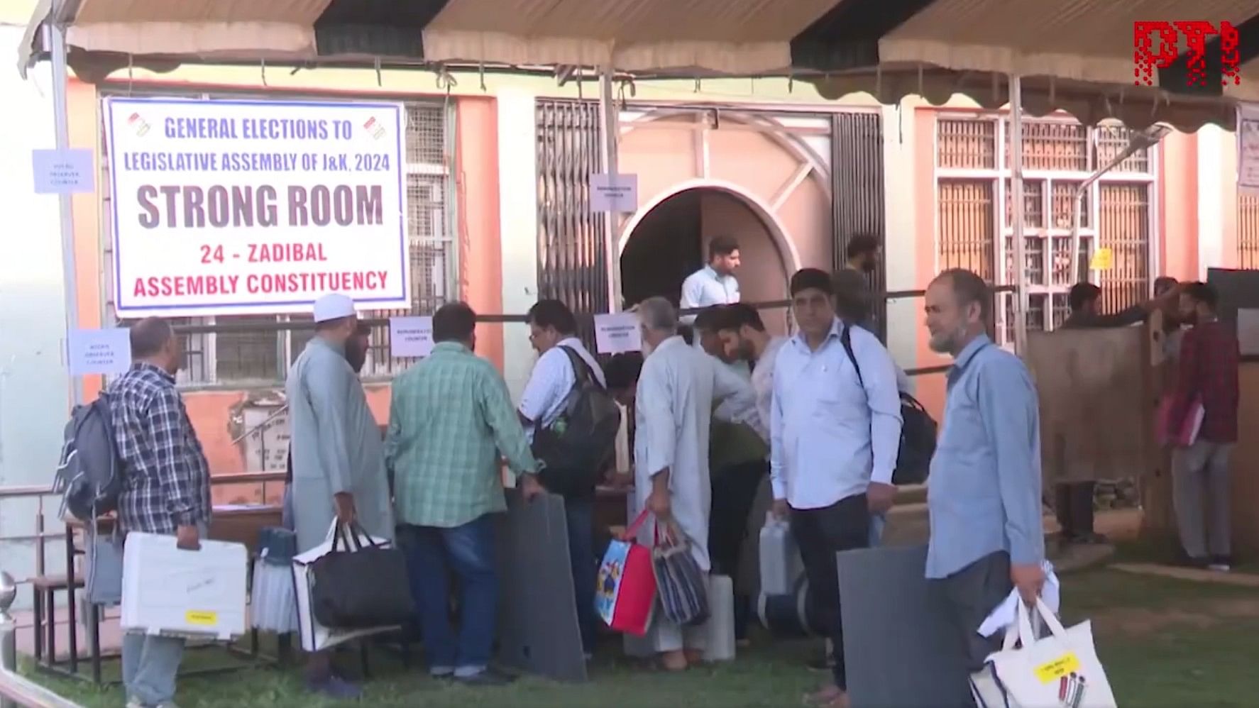 <div class="paragraphs"><p>Officials in front of a Strong Room to collect polling material.</p></div>