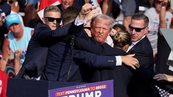 <div class="paragraphs"><p>In this file photo Republican presidential candidate and former US President Donald Trump gestures with a bloodied face while he is assisted by US Secret Service personnel after he was shot in the right ear during a campaign rally at the Butler Farm Show in Butler, Pennsylvania, US.&nbsp;</p></div>