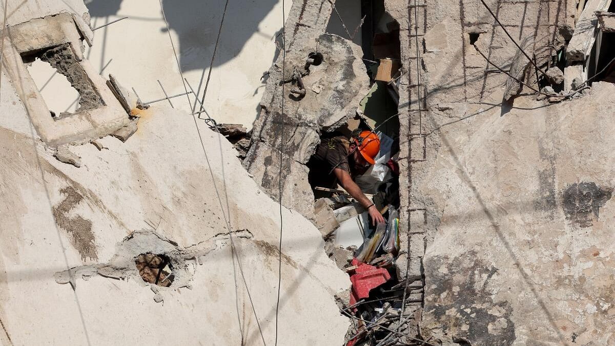 <div class="paragraphs"><p>People gather near the site of an Israeli strike in Beirut's southern suburbs.</p></div>