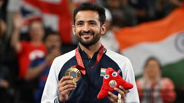 <div class="paragraphs"><p>Shuttler Nitesh Kumar celebrates on the podium after winning the gold medal at the Paris Paralympics.</p></div>