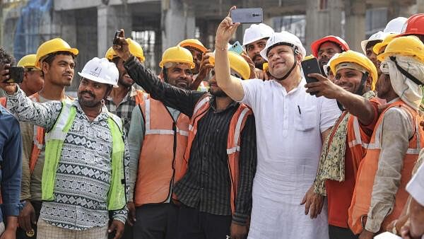 <div class="paragraphs"><p>Union Railway Minister Ashwini Vaishnaw takes selfie with workers during an inspection visit of the under-construction Gandhinagar Railway Station, in Jaipur, Tuesday, September 24, 2024. </p></div>