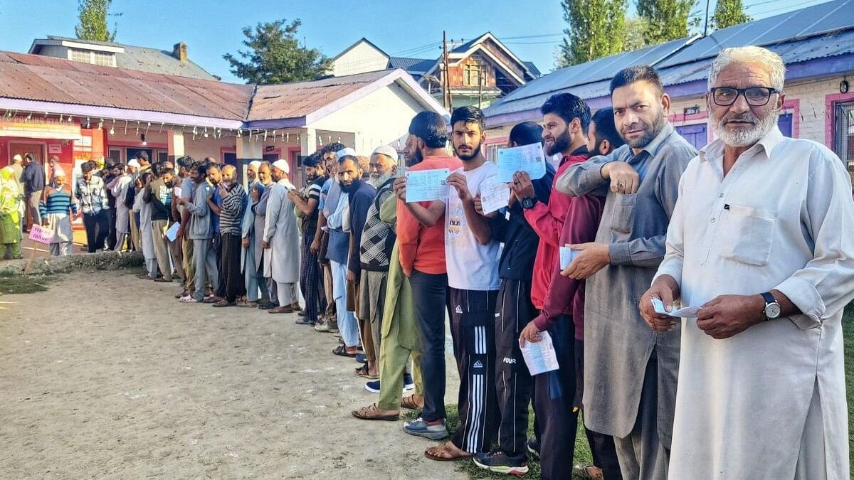 <div class="paragraphs"><p>Voters stand in a queue to cast their votes during the first phase of Jammu and Kashmir Assembly elections.</p></div>