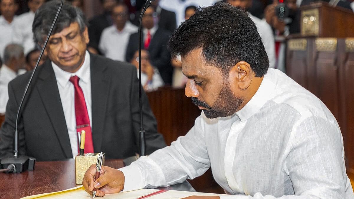 <div class="paragraphs"><p>Anura Kumara Dissanayake signs documents after taking oath as Sri Lanka's new president during a ceremony, in Colombo, Sri Lanka.</p></div>