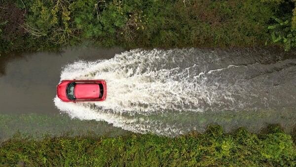 <div class="paragraphs"><p>A drone view shows a car driving along a flooded road following heavy rain, near Bicester, Britain, September 24, 2024. </p></div>