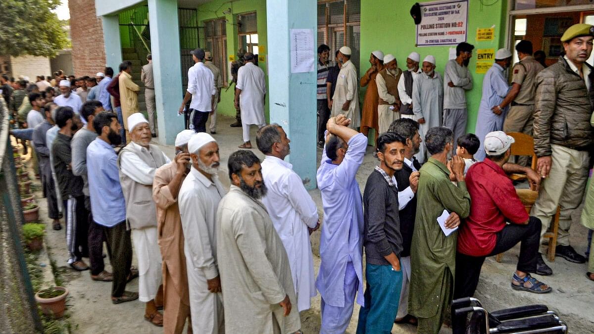 <div class="paragraphs"><p>Voters stand in a queue at a polling station to cast votes during the second phase of Jammu and Kashmir Assembly elections, in Srinagar, Wednesday, September 25, 2024.</p></div>