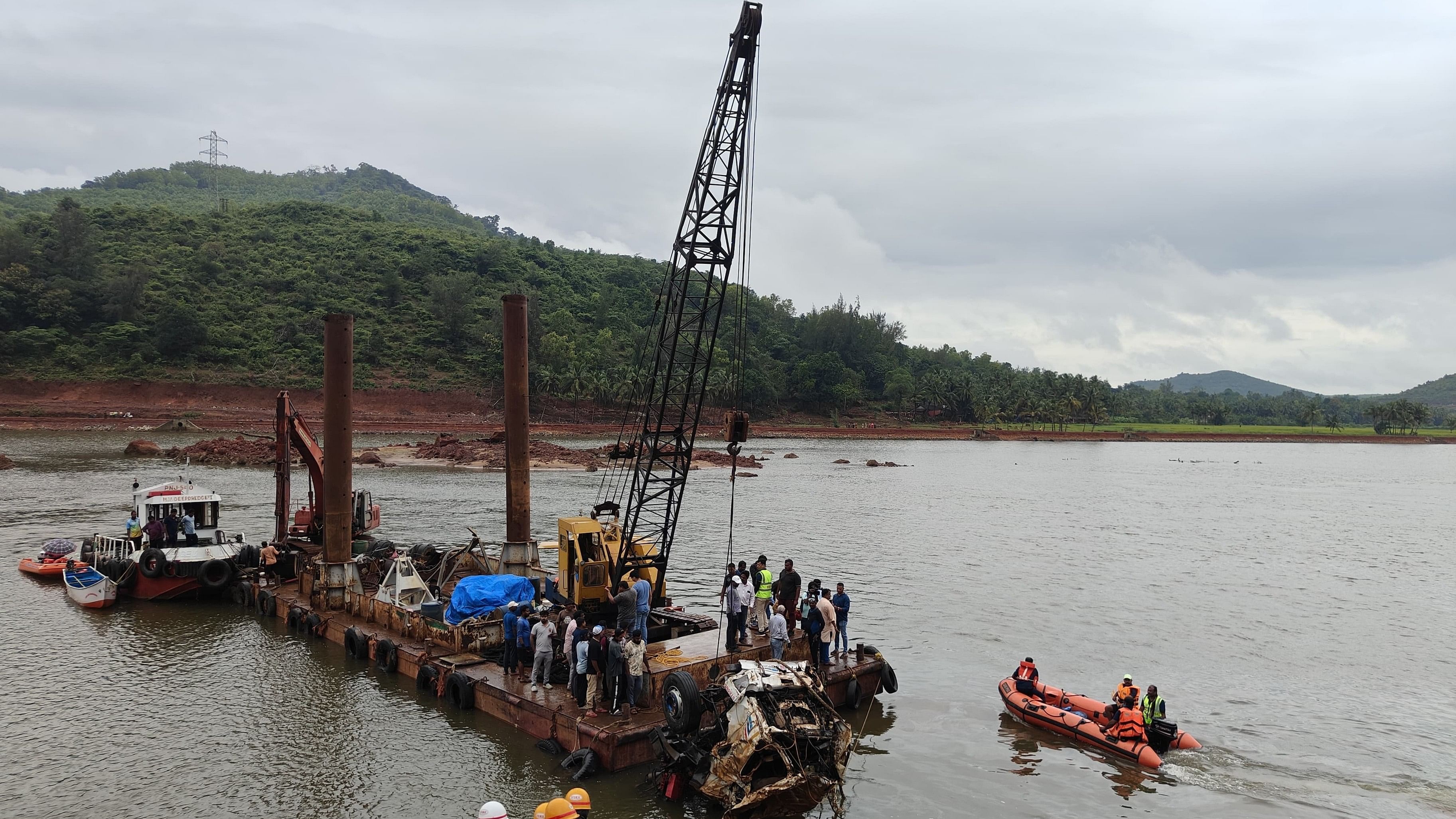 The lorry from Kerala which had gone missing following a landslide at Shirur in Uttara Kannada district two months ago is lifted out of River Gangolli using a crane on Wednesday.