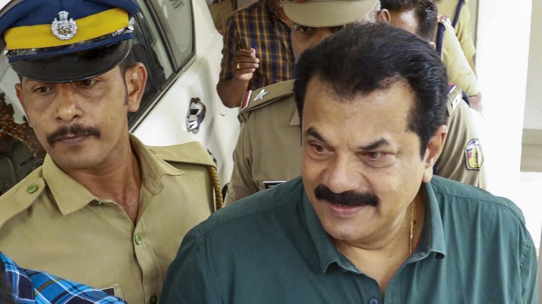 <div class="paragraphs"><p>Police personnel take MLA and actor Mukesh after he was interrogated by AIG in a sexual assault case filed by female actors, at the Coastal Police Office in Kochi.</p></div>