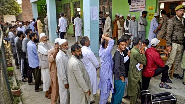 <div class="paragraphs"><p>Voters stand in a queue at a polling station to cast votes during the second phase of Jammu and Kashmir Assembly elections. </p></div>