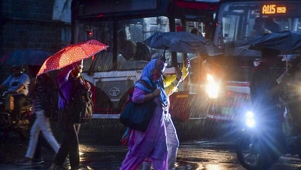 <div class="paragraphs"><p>Pedestrians cross a road amid rain, in Mumbai, Wednesday, Sept. 25, 2024. </p></div>