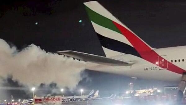 <div class="paragraphs"><p>Smoke emnates from the tail end of a Dubai-bound Emirates flight at the Chennai International Airport.</p></div>