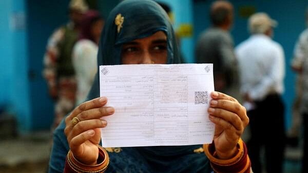 <div class="paragraphs"><p>A woman voter shows her identification card outside a polling station during the second phase of J &amp; K Assembly polls, at Lamberi in Nowshera, in Rajouri district.</p></div>