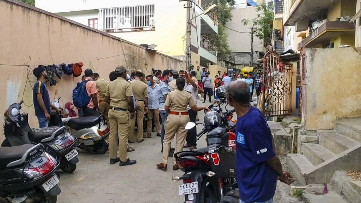 <div class="paragraphs"><p>Police and locals near the crime scene after a woman was murdered in Malleswaram, Bengaluru.</p></div>