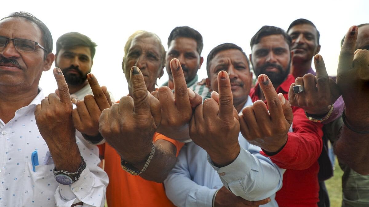 <div class="paragraphs"><p>Villagers show their inked fingers after casting votes during the second phase polling in Kashmir's Rajouri district.&nbsp;</p></div>