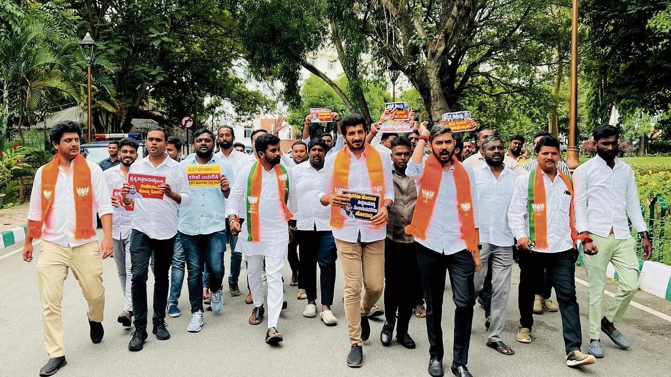 <div class="paragraphs"><p>BJP workers led by Doddaballapur MLA Dheeraj Muniraju march towards the chief minister’s residence in Bengaluru on Wednesday. </p></div>