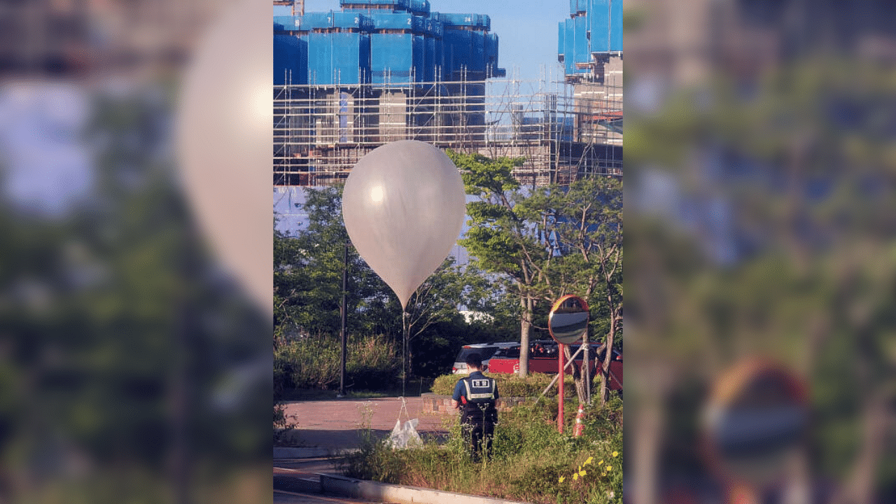 <div class="paragraphs"><p>A balloon believed to have been sent by North Korea, carrying various objects including what appeared to be trash, is pictured in Incheon</p></div>