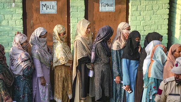 <div class="paragraphs"><p>Voters stand in a queue at a polling station to cast votes during the second phase of Jammu and Kashmir Assembly elections, in Srinagar district.</p></div>