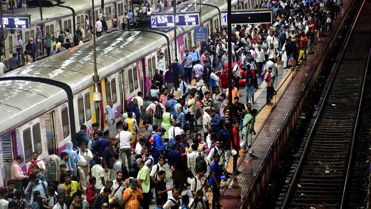 <div class="paragraphs"><p>Commuters stranded at Chhatrapati Shivaji Terminus (CSMT) as local train services got delayed due to rain, in Mumbai.</p></div>