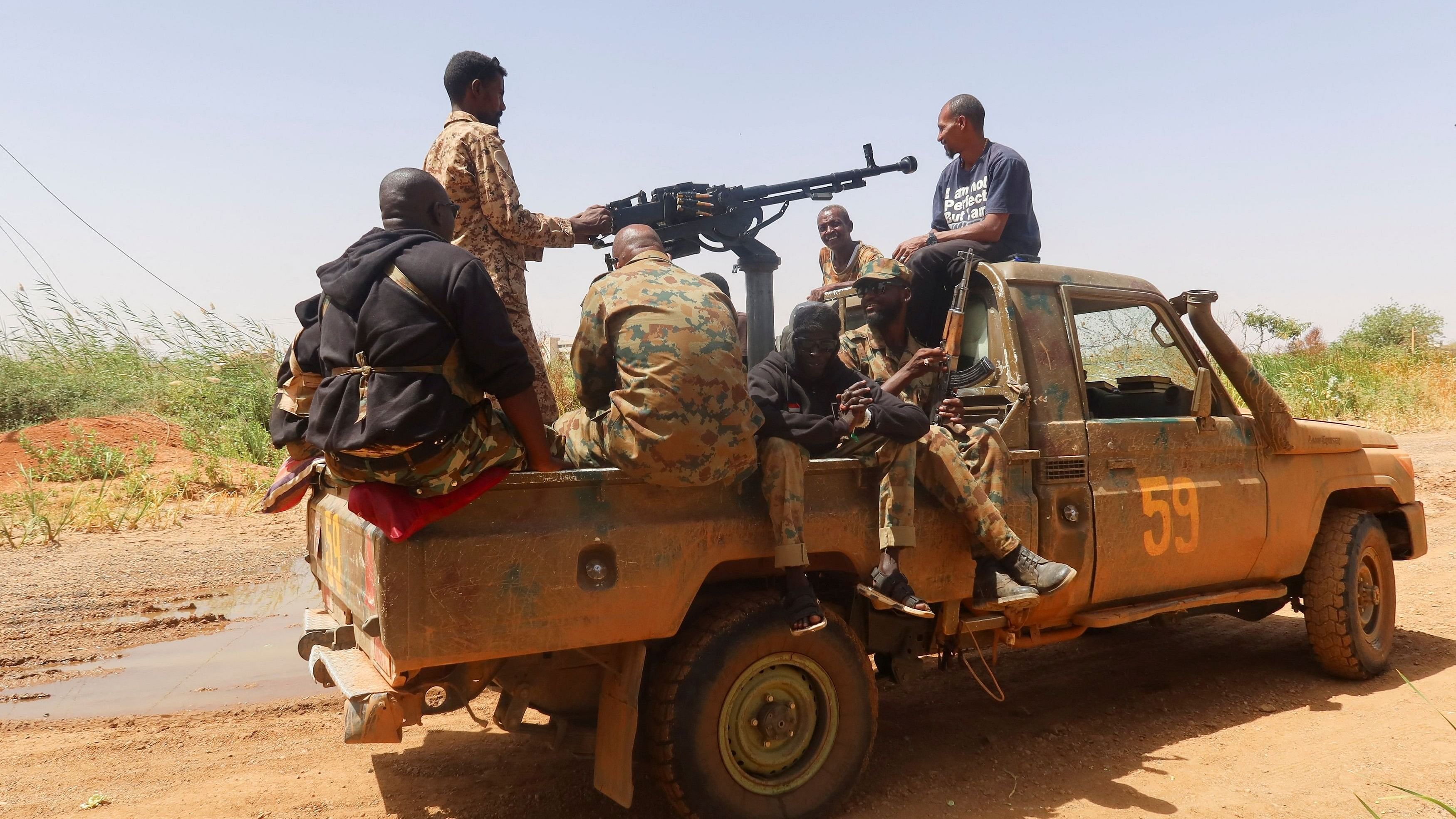 <div class="paragraphs"><p>Members of Sudanese armed forces sit on an army vehicle in Omdurman, Sudan.</p></div>