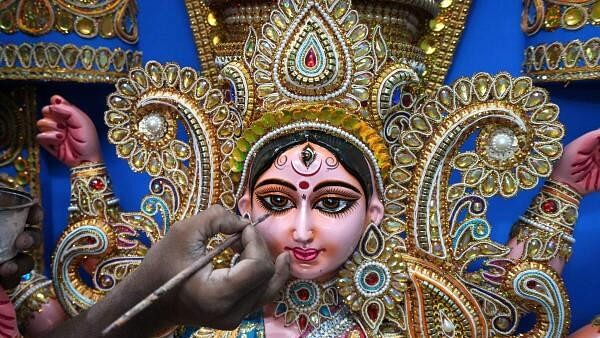 <div class="paragraphs"><p>An artist gives finishing touches on a fibre glass made Devi Durga idol, to be sent to the US for Durga Puja festivities, at his studio in village Kumatuli, in Kolkata.</p></div>