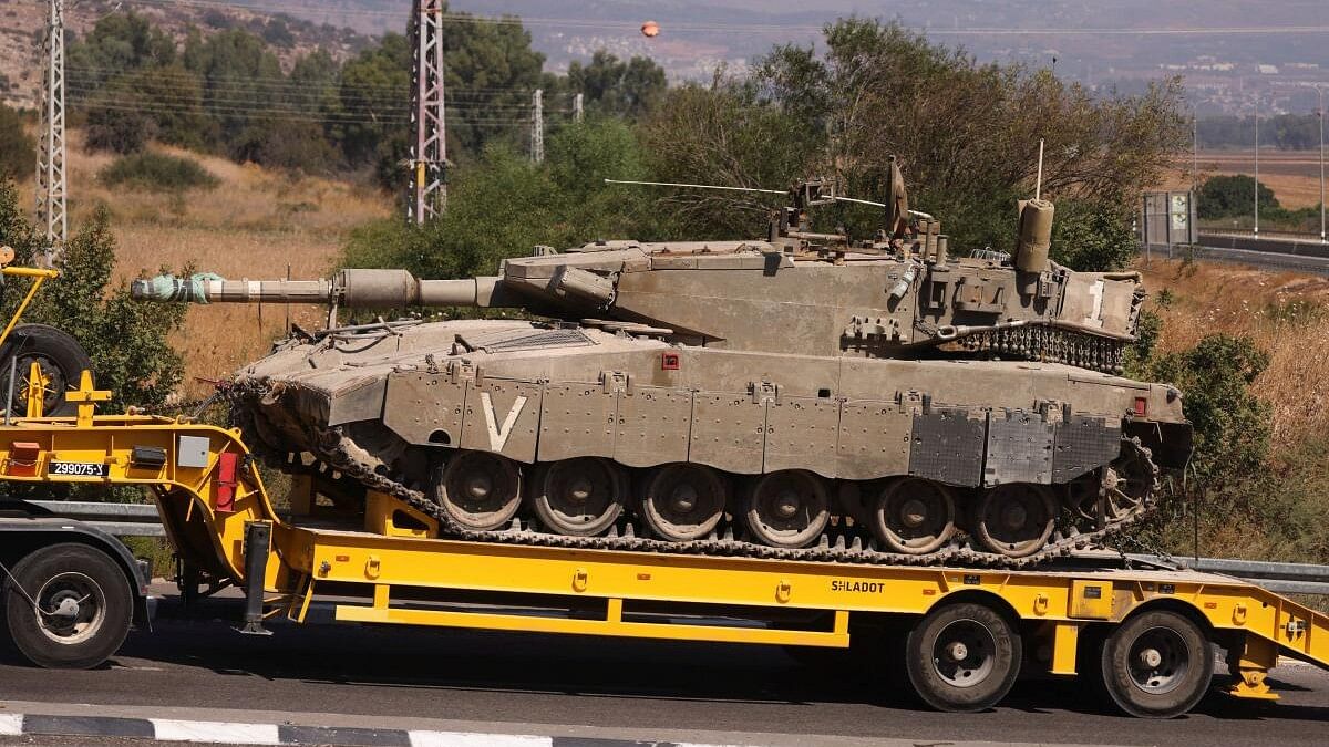 <div class="paragraphs"><p>An Israeli army tank is transported, amid cross-border hostilities between Hezbollah and Israel.</p></div>