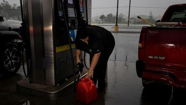 <div class="paragraphs"><p>A woman fills up a container with gas as Hurricane Helene intensifies before its expected landfall on Florida’s Big Bend, in Cross City, Florida, US September 25, 2024. </p></div>