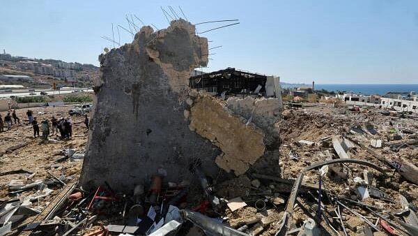 <div class="paragraphs"><p>People inspect the damage at the site of an Israeli strike that hit the Lebanese seaside town of Jiyeh early on Wednesday, Lebanon.</p></div>