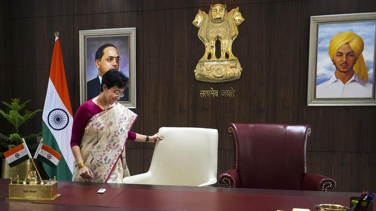 <div class="paragraphs"><p>Delhi CM Atishi looks on at her chair with an empty one next to her symbolising Arvind Kejriwal's absence</p></div>