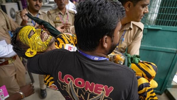 <div class="paragraphs"><p>Bangladeshi supporter 'Tiger Robi' being escorted out of  the Green Park Stadium, in Kanpur, Friday, Sept. 27, 2024, during the 2nd Test match between India and Bangladesh.</p></div>