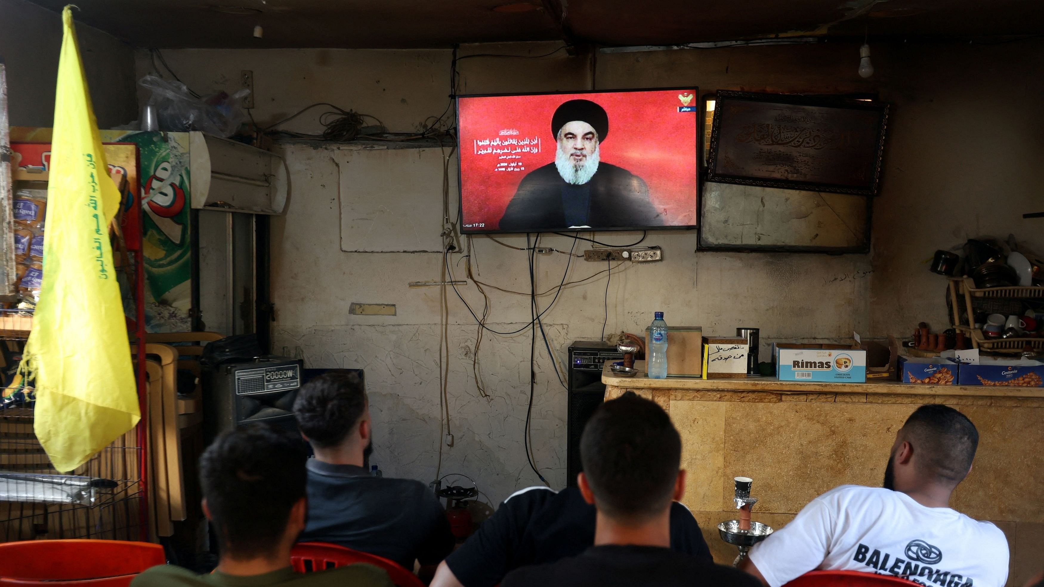 <div class="paragraphs"><p>People watch Lebanon's Hezbollah leader Sayyed Hassan Nasrallah delivering a televised address.</p></div>