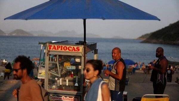 <div class="paragraphs"><p>A man sells a tapioca dish, in Praia Vermelha beach in Rio de Janeiro, Brazil.</p></div>