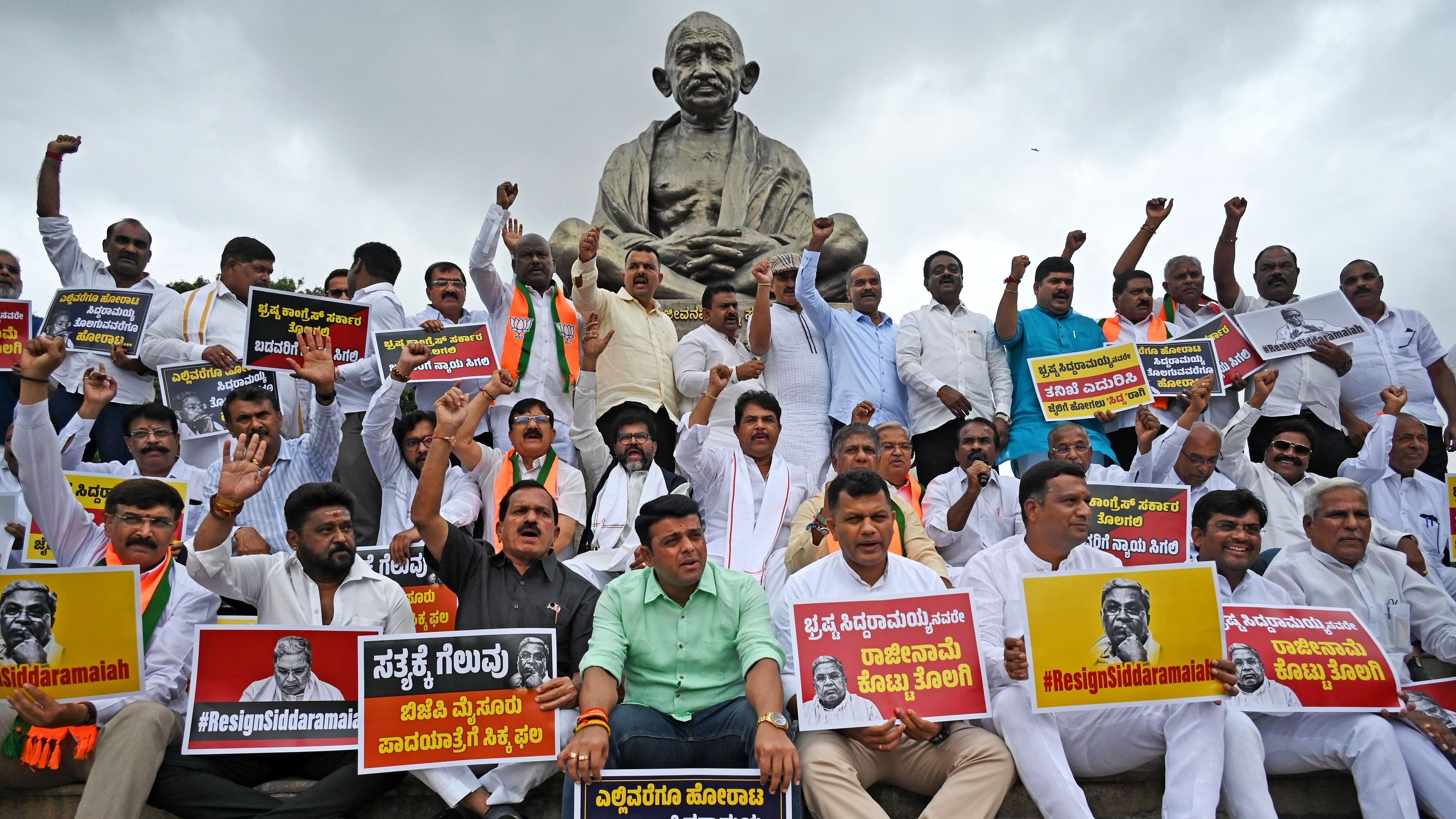 <div class="paragraphs"><p>BJP lawmakers and leaders stage a protest in front of Mahatma Gandhi statue on the premises of Vidhana Soudha on Thursday, demanding Chief Minister Siddaramaiah’s resignation. </p></div>