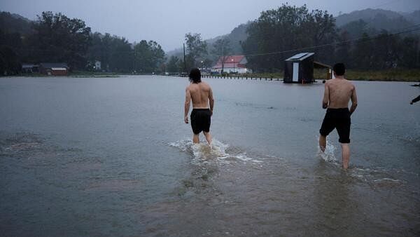 <div class="paragraphs"><p>Residents walk through a flooded field as they play outside in the rain, as Hurricane Helene approaches in the North Carolina mountains, in Valle Crucis, North Carolina, US, September 26, 2024.</p></div>