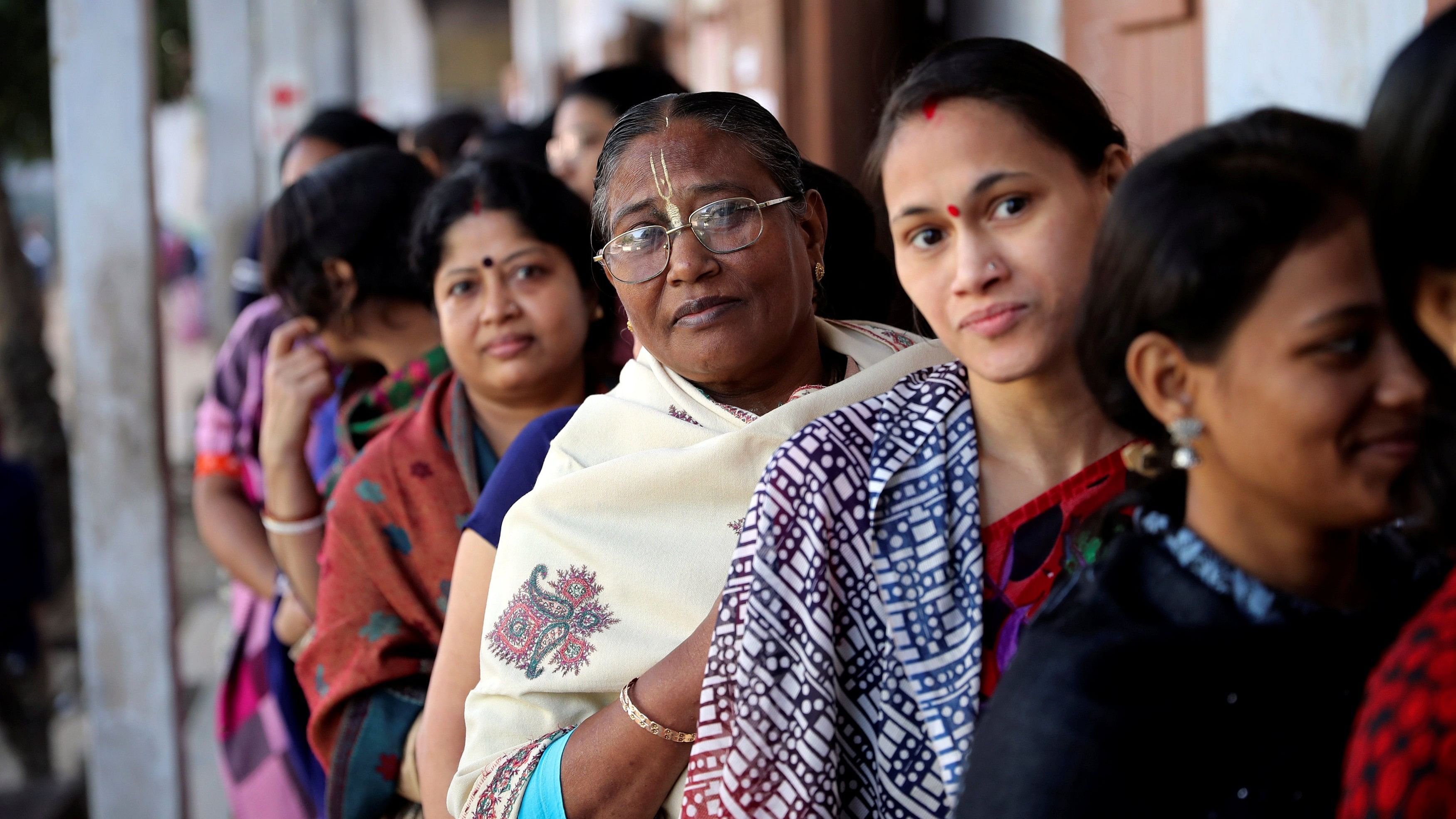 <div class="paragraphs"><p>Hindu voters wait to cast their vote outside a voting center during the general election in Dhaka</p></div>