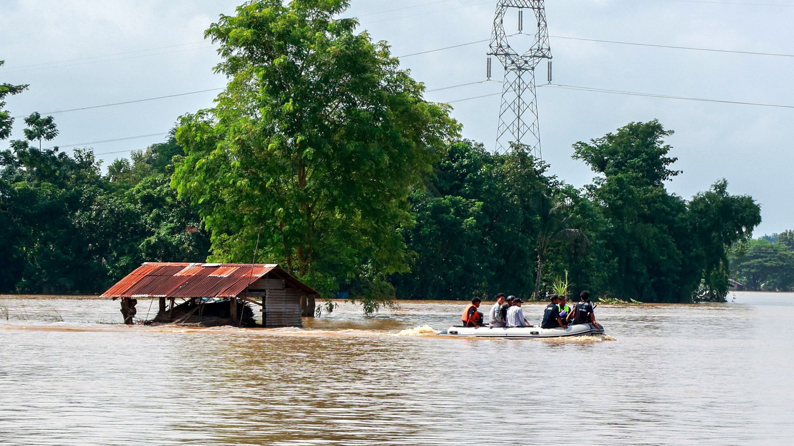 <div class="paragraphs"><p>Volunteers ride a boat through a flooded area, searching for stranded people following the impact of Typhoon Yagi.&nbsp;</p></div>